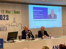 Michel Barnier, left, alongside FIEC president Philip Crampton, speaking at the recent FIEC conference in Rome
