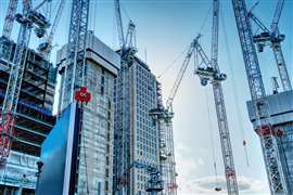 Cranes surrounding high-rise buildings under construction in London
