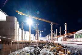 A floodlit construction site at night 