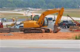 A construction crew works on an airport runway. (Image: Adobe Stock)