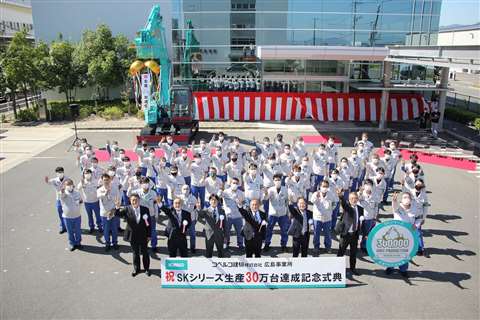 Kobelco staff take part in a commemorative photo at the factory in Japan